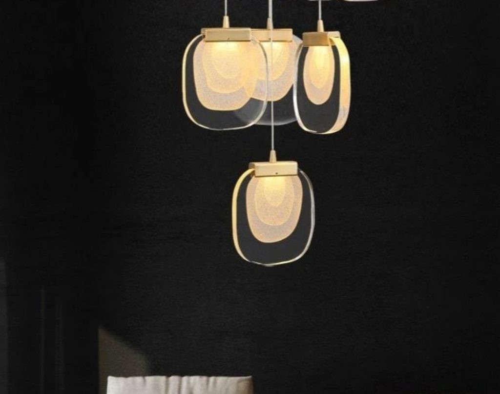 Four dangling lights in a dark room.